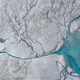 A stream of meltwater flowing into a moulin on the Greenland Ice sheet